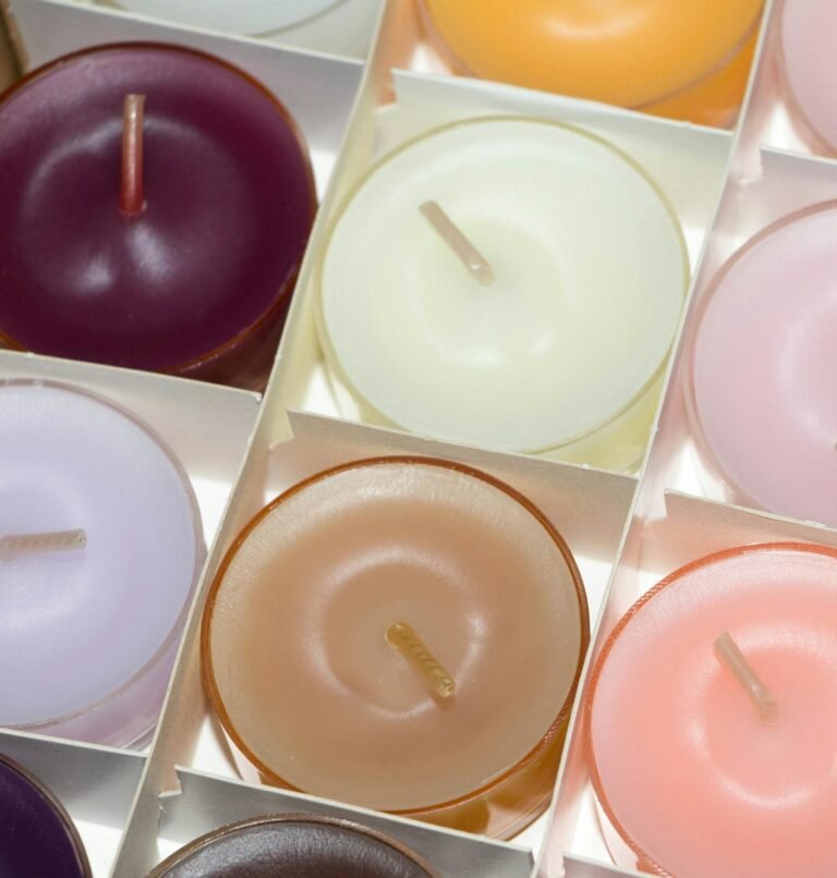 Colorful array of scented tea light candles in a decorative setting.