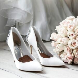 Elegant bridal shoes and bouquet of roses perfect for wedding inspirations.